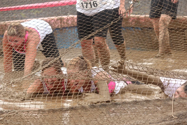 some girls laying on the ground in a net