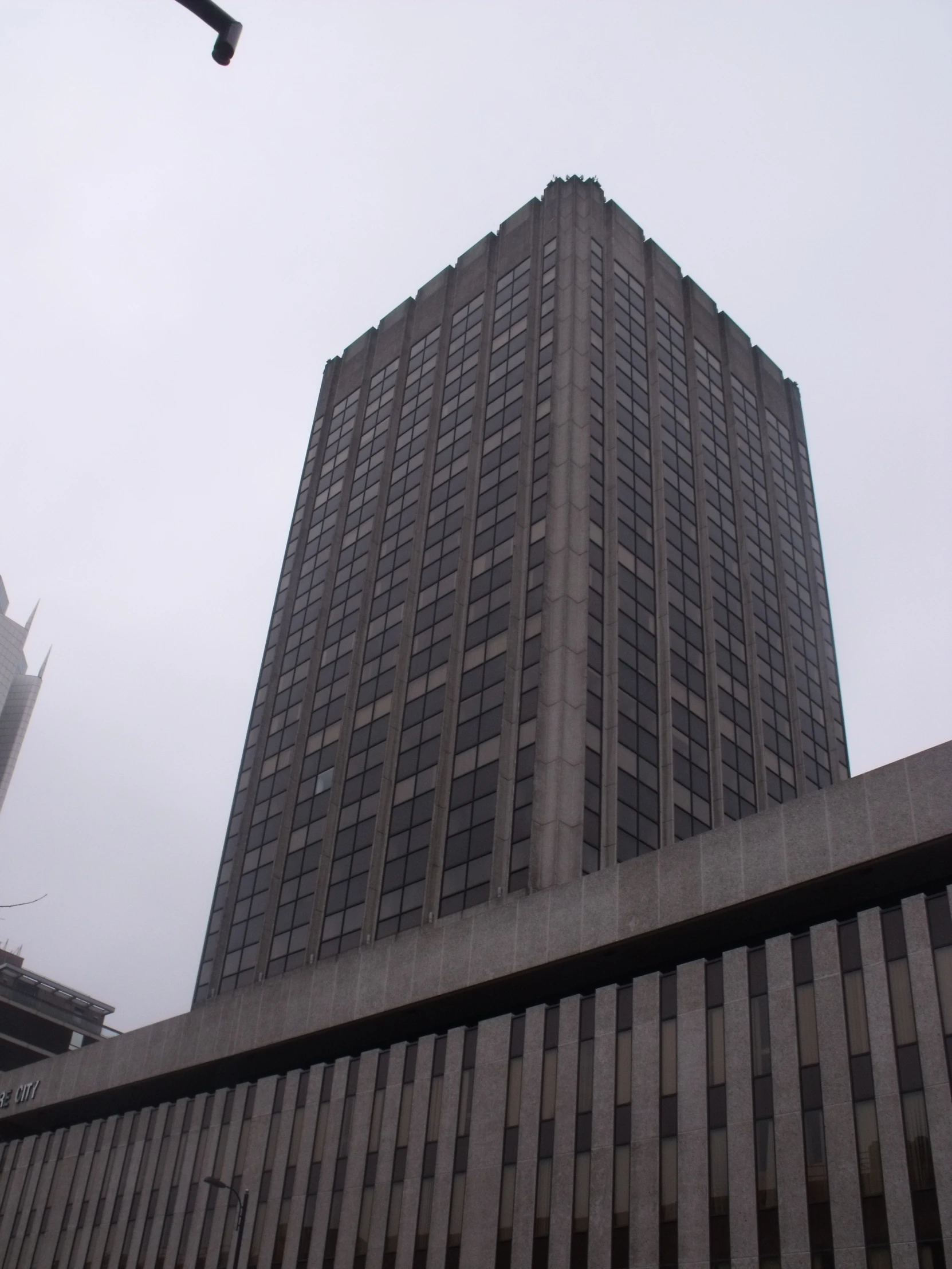 a tall gray building that has lines on the outside