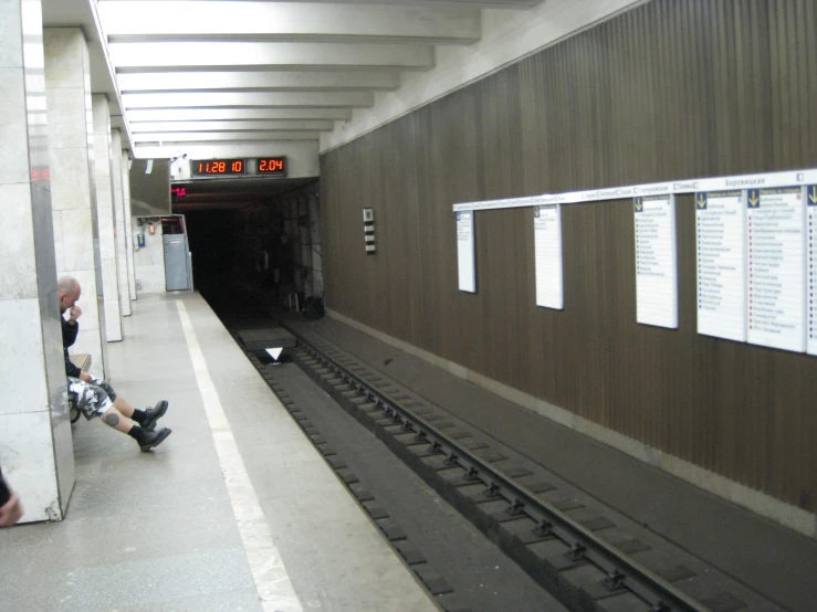 some people are waiting at a train station