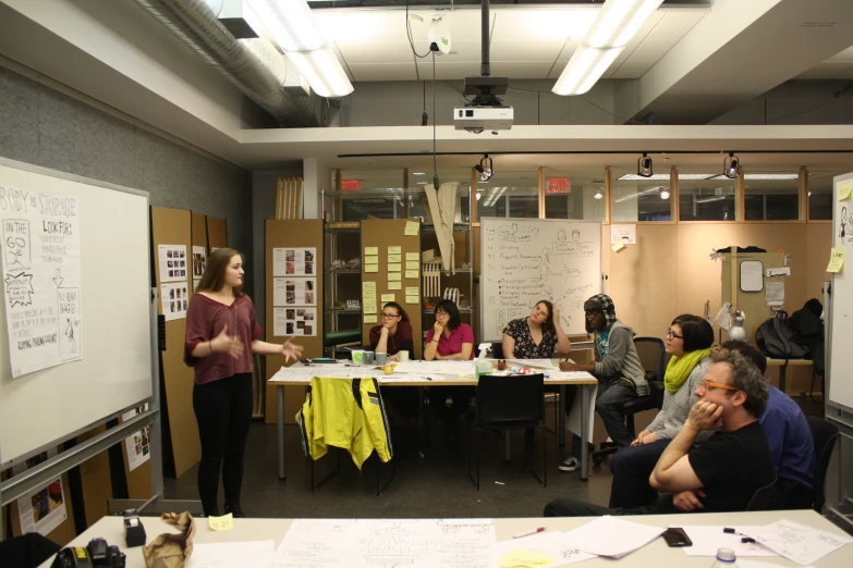 several people sitting at a table having a discussion