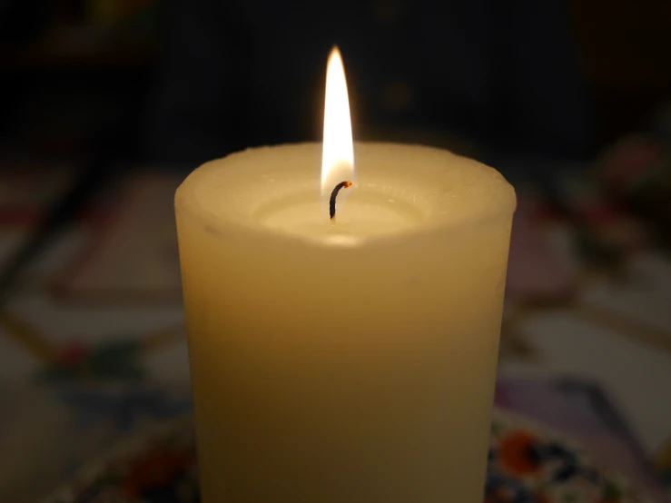 a lit candle sitting on top of a table