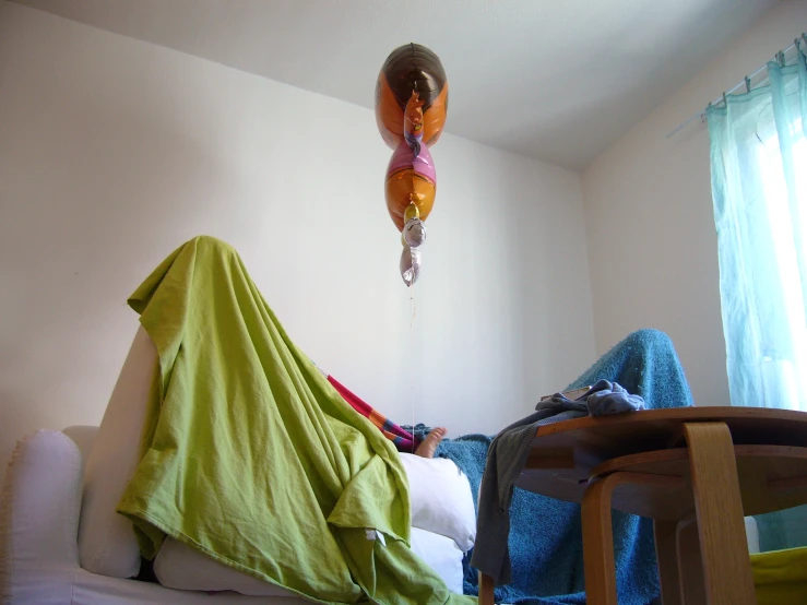 a balloon that looks like a fish on a string hangs from the ceiling