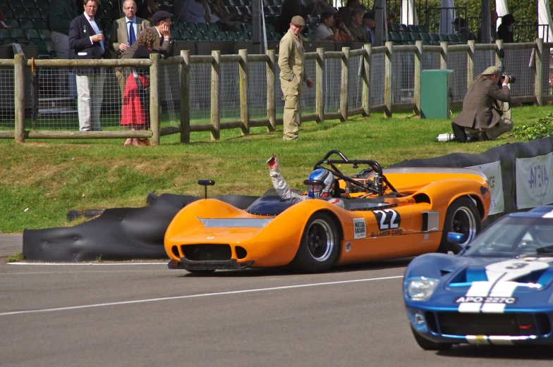 a vintage race car driving on a road