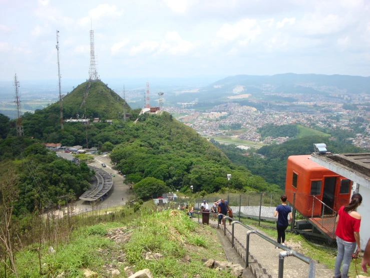 people standing at the top of a hill looking out into the distance