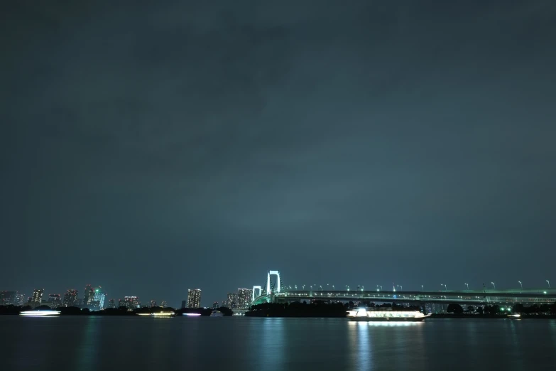 dark skies and some lights reflecting on water