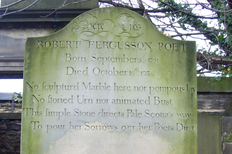 a gravestone with some writing on it