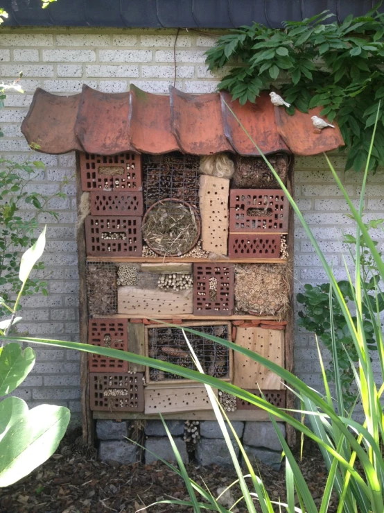 a close up of a bunch of bug houses next to a building