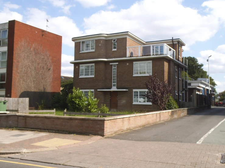 two brick buildings on the corner of a street