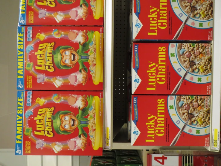 three lucky charms cereal boxes sitting on a supermarket shelf