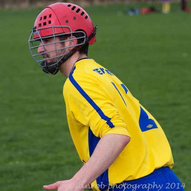 the boy in the red helmet is preparing to throw the ball