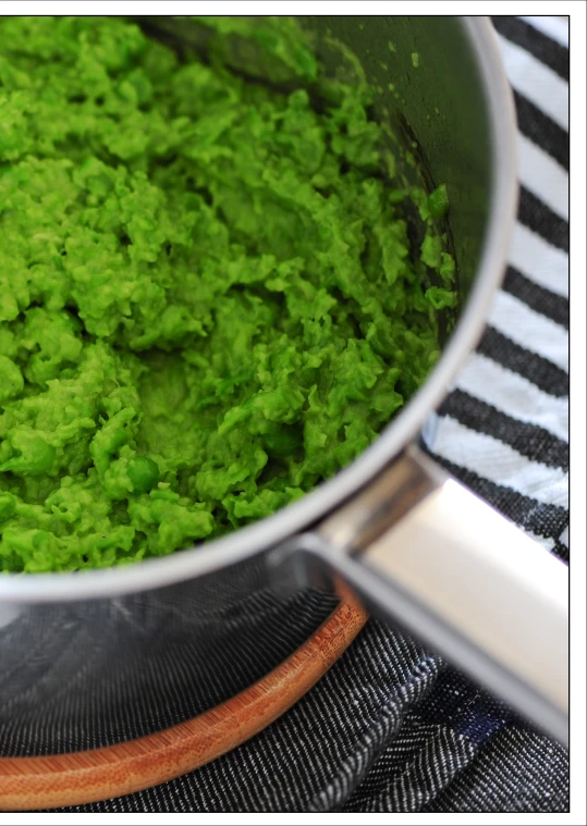 a large pan filled with green colored substance