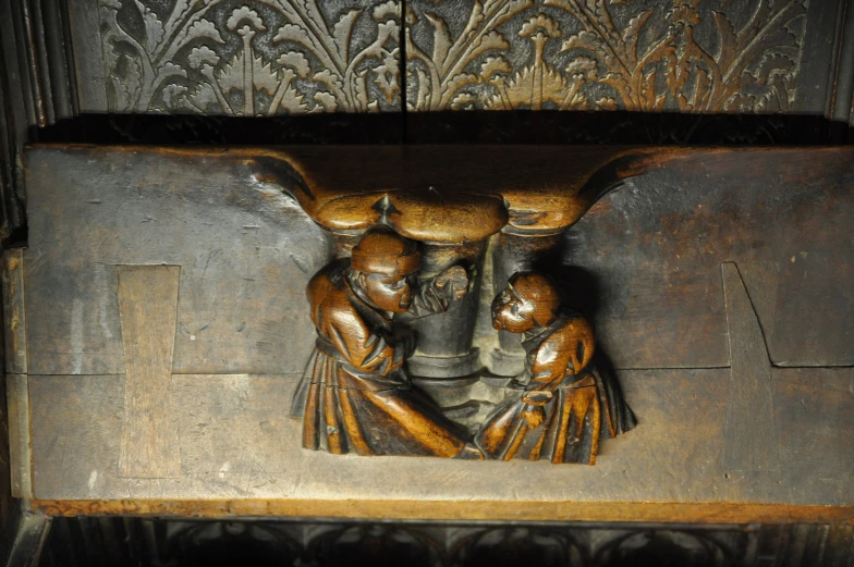 an ornate carved wood carving of three women