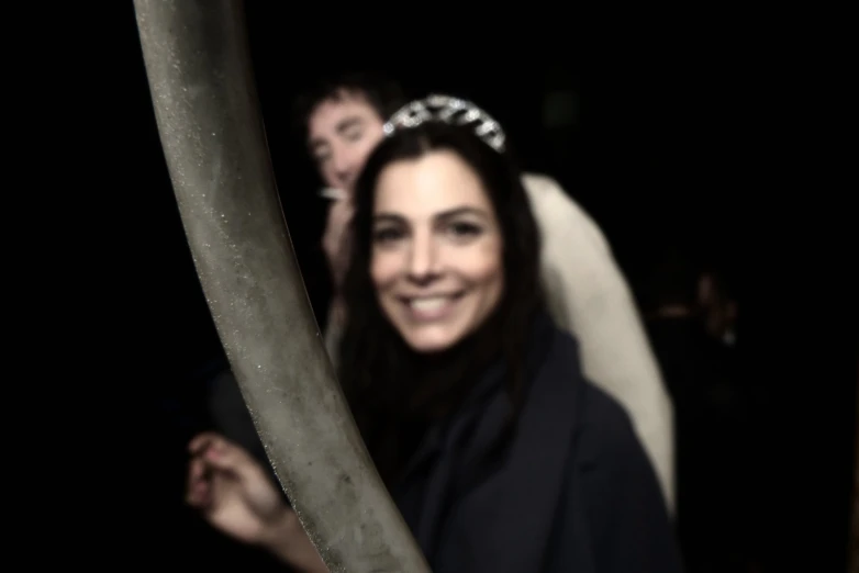 a smiling bride holds onto a stick