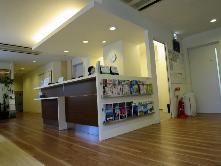 a big long room with a table and some magazines