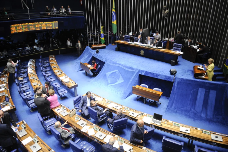 a group of people siting at a table in front of a speaker