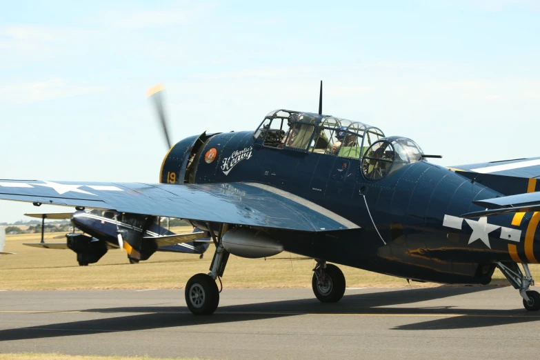 a military airplane sitting on the tarmac with people in it