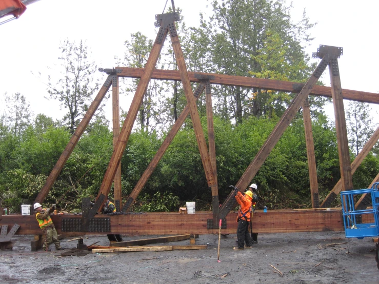 workers work on framing a large bridge in the day