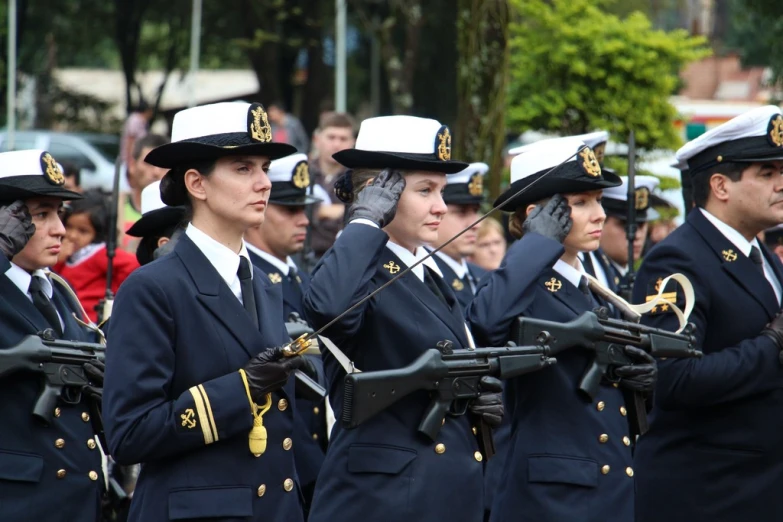 a band wearing blue uniforms marching in formation