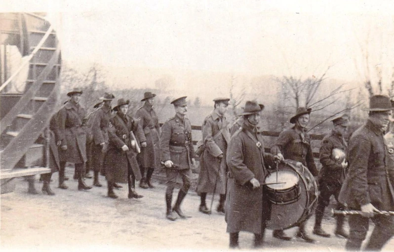 soldiers walking outside and playing the drums