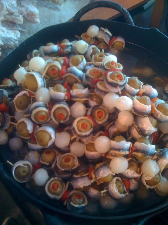 a pan filled with lots of food on top of a stove