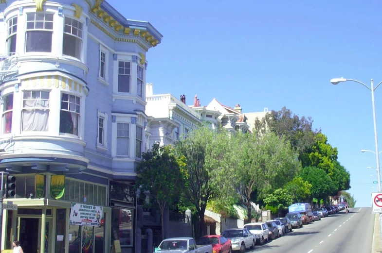 many cars are parked along this long city street