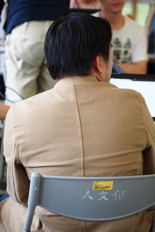 a person in a brown shirt sitting down