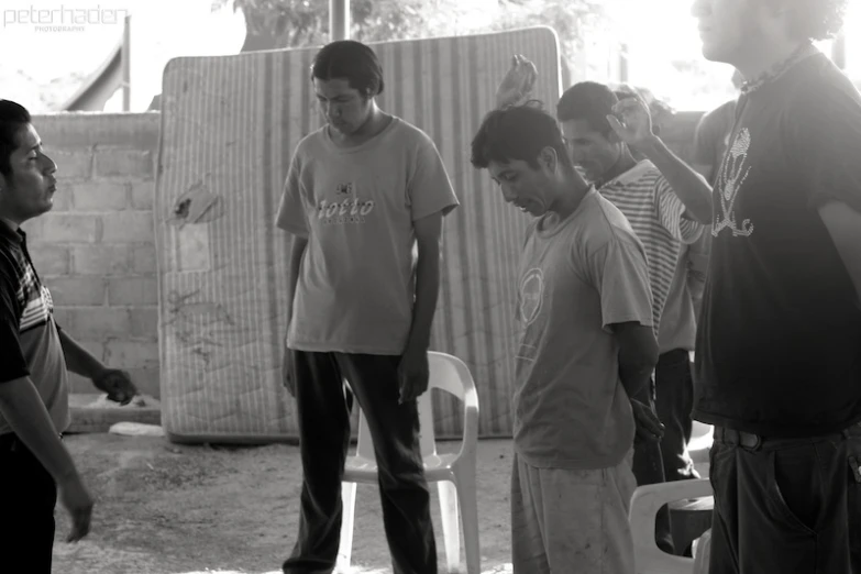 a group of young men standing around each other