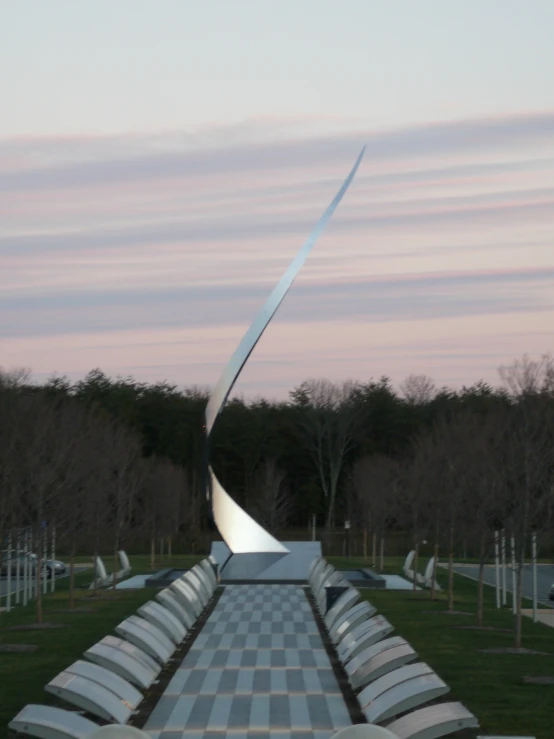 a large white statue surrounded by lots of benches