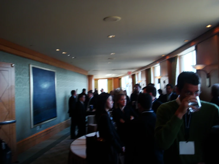 people stand in a hall for a ceremony