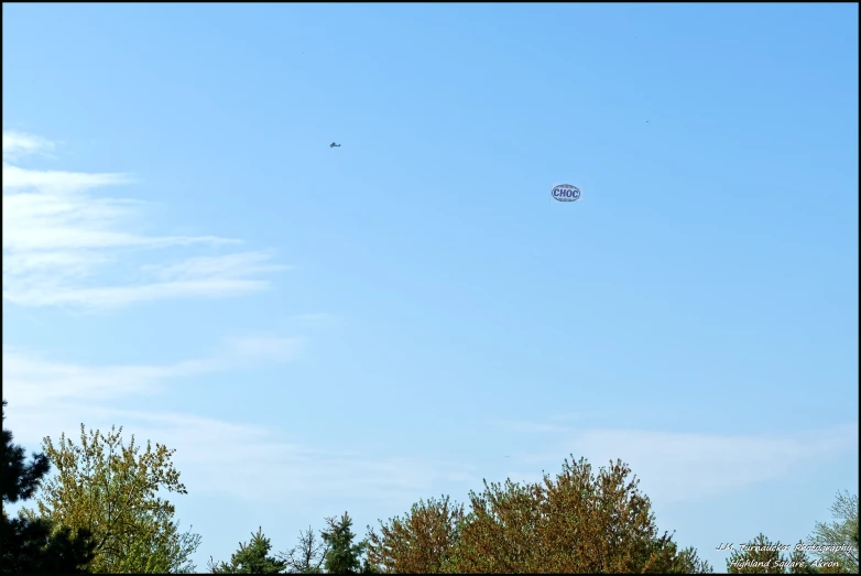 a clear sky with some kites flying in the air