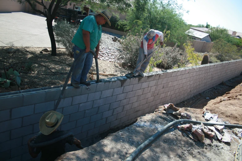 two people are building soing on the side of a building