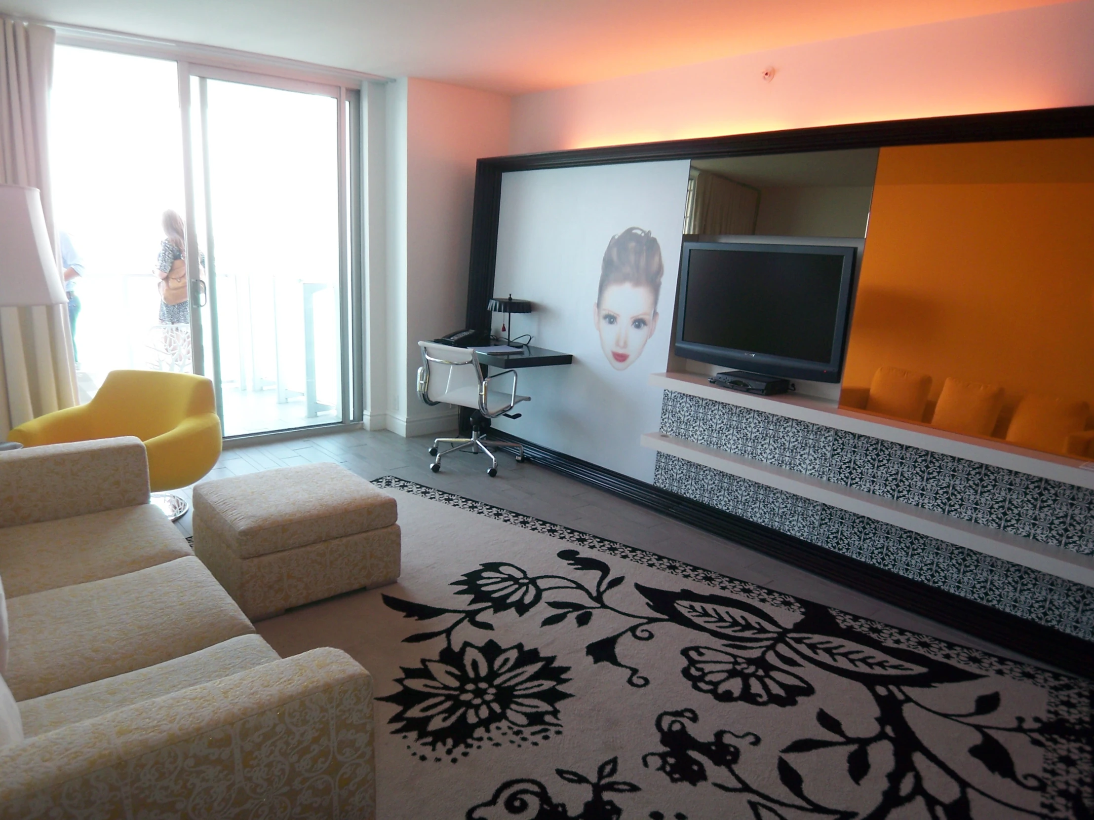 a living room filled with white furniture and orange walls