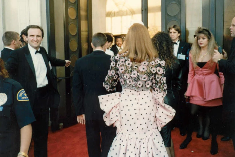 a group of people on red carpet next to each other