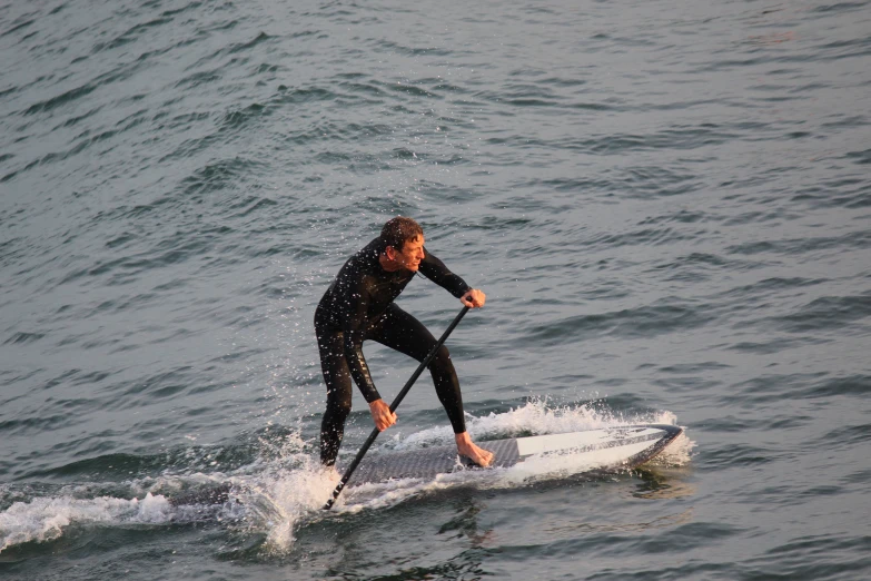 a man is on his surfboard on the water