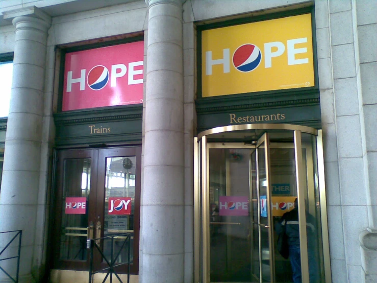 two doors to an empty shop with hope written on the front
