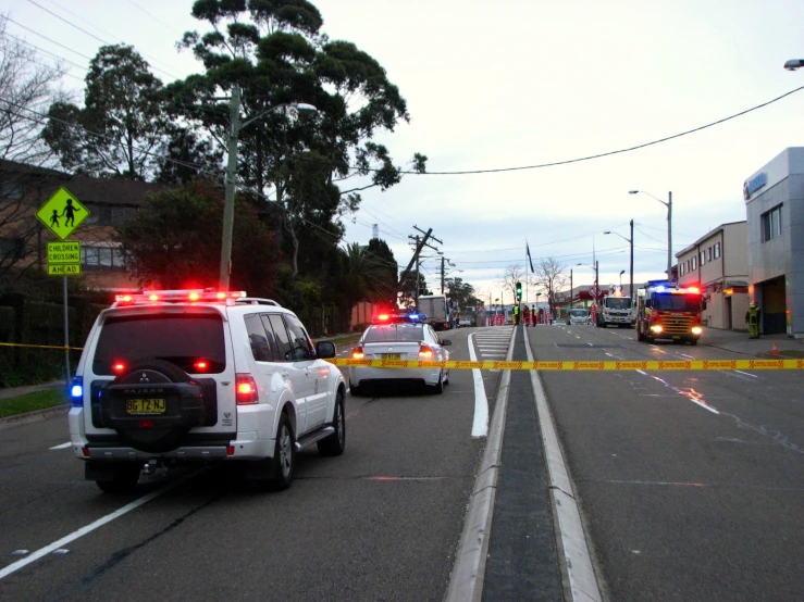 police cars sitting on the side of a road