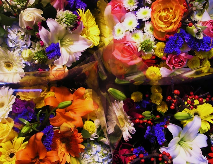 a mixture of flowers are stacked on top of each other