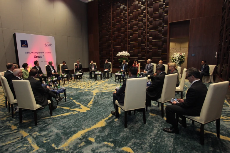 a group of people in chairs with one person sitting in the middle