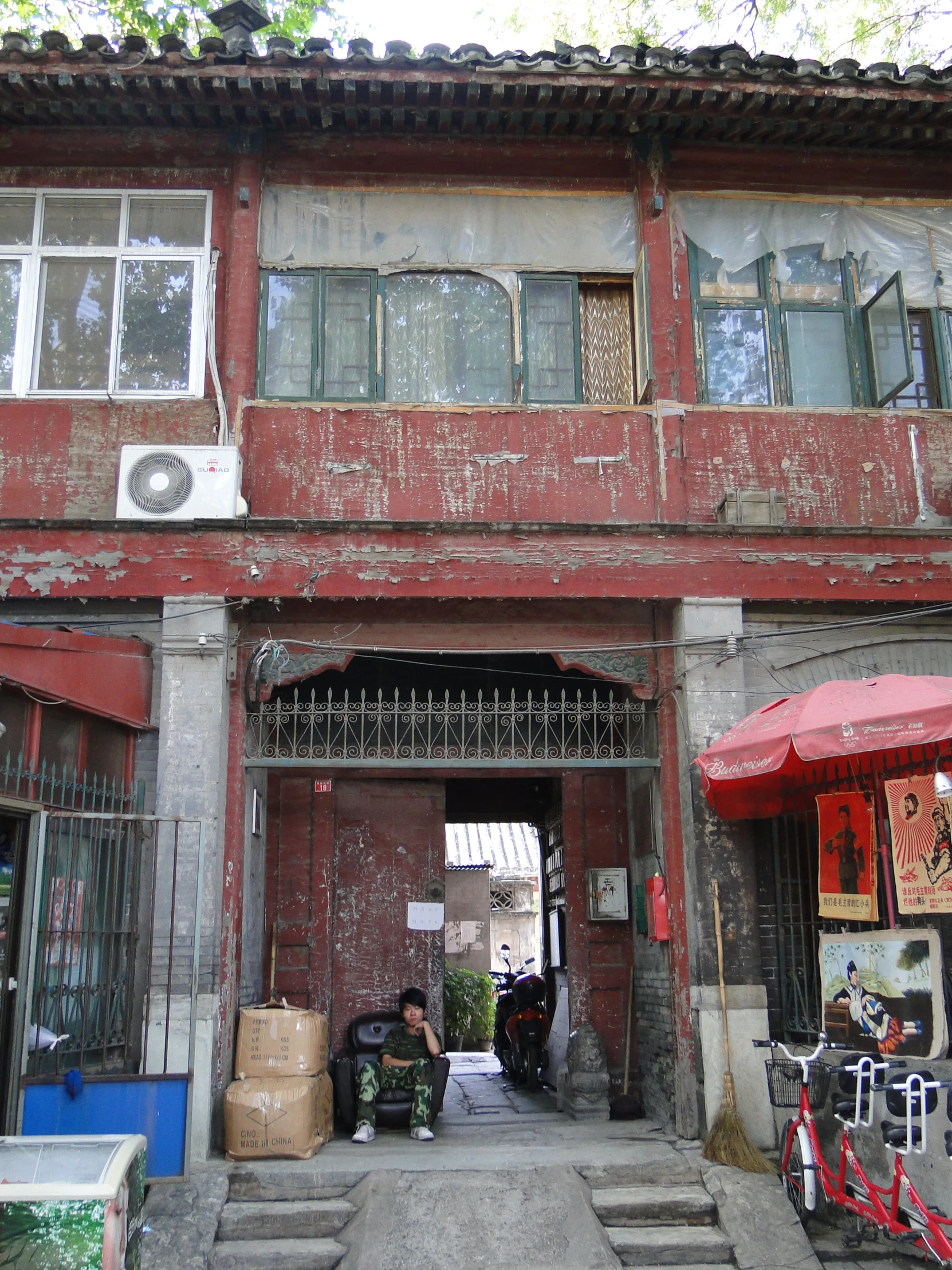 a red building with an umbrella and windows