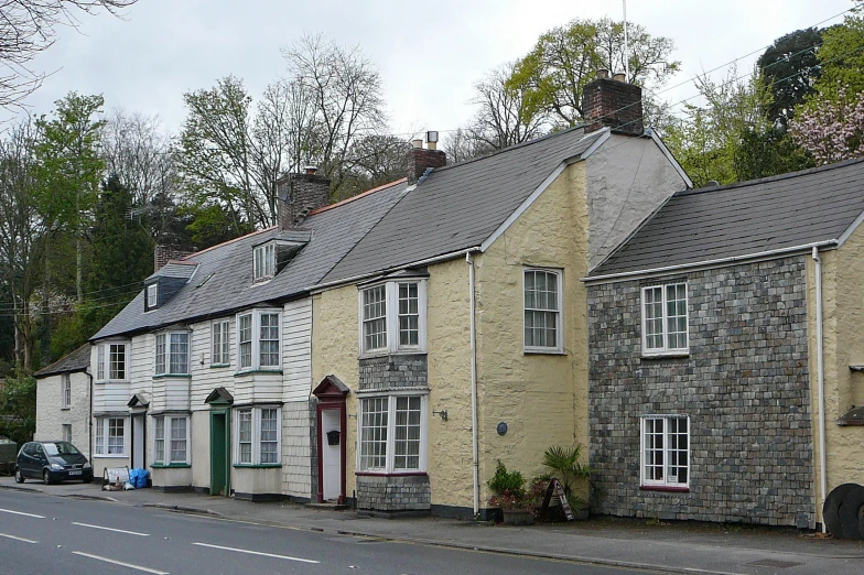 a row of stone house buildings on the side of a road