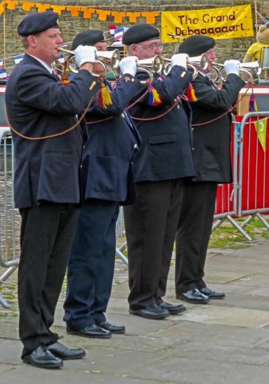 three men in dress clothes holding a trumpet together