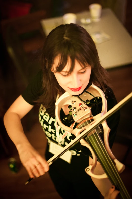 woman holding her violin as she waits for soing