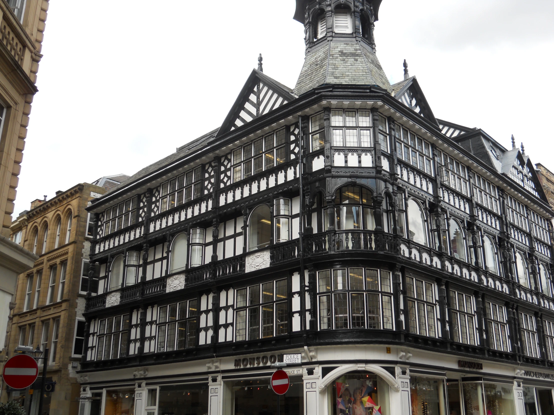 a black and white building with lots of windows and a clock on top