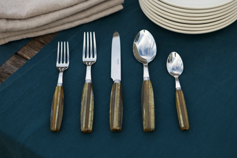 a table is set with silverware and plates