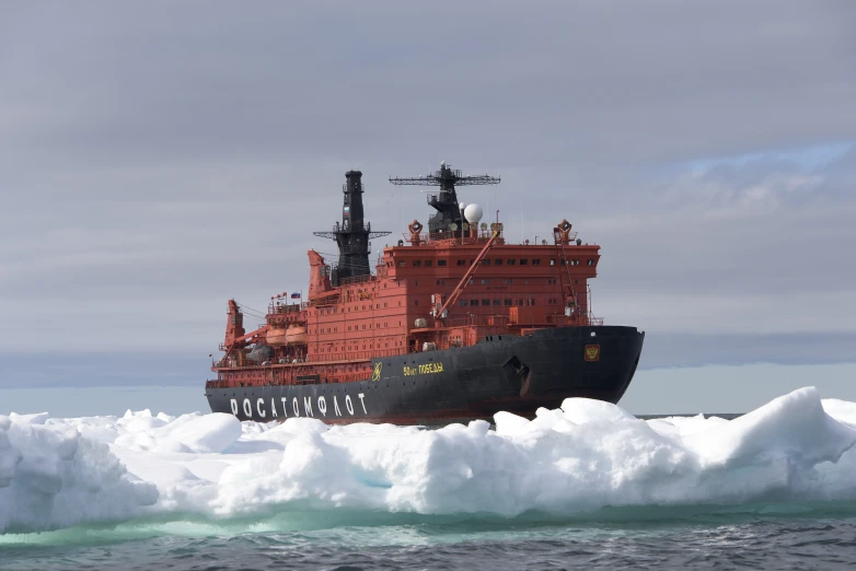 an icebreaker near a ship in the middle of the ocean