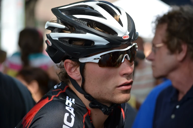 a man in a bib bike helmet and goggles