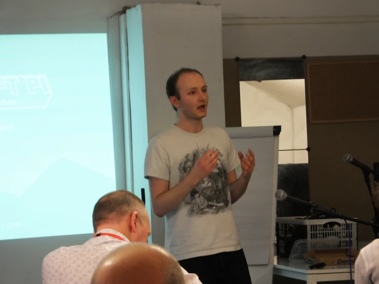 a man holding a white box while standing next to two other men