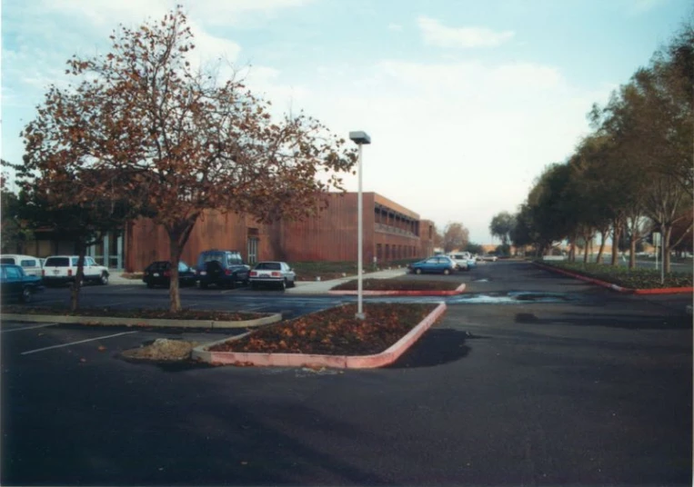 an empty street with a small parking lot