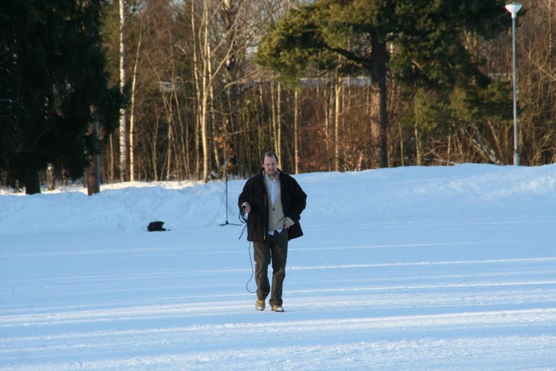 a man cross country skiing across a snow covered field