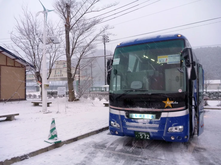 a bus waits on the street in the snow